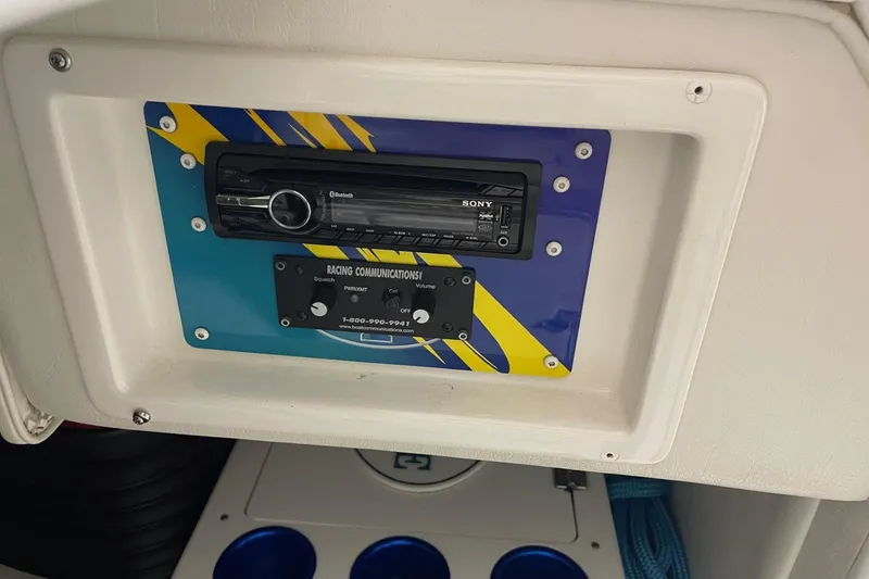 Slide: The Image of 2002 Cigarette 38 Top Gun boat dashboard with Sony Bluetooth stereo and racing communications panel. - 40