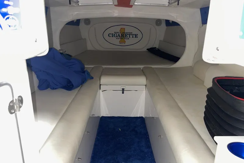 Slide: The Image of Interior of a 2002 Cigarette 38 Top Gun boat with white seating and blue accents. - 42