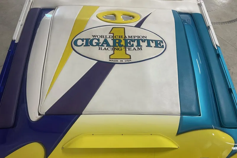 Slide: The Image of 2002 Cigarette 38 Top Gun boat with vibrant racing team graphics. - 7