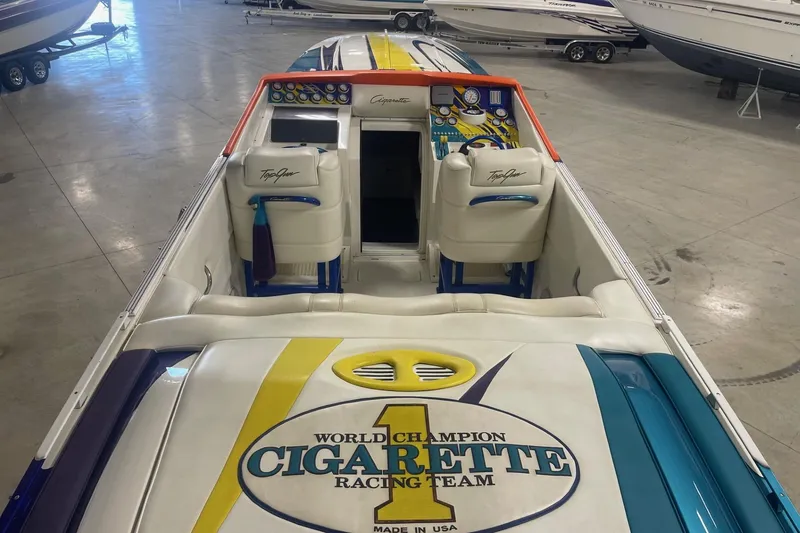 Slide: The Image of 2002 Cigarette 38 Top Gun boat interior with racing team logo in a showroom. - 8