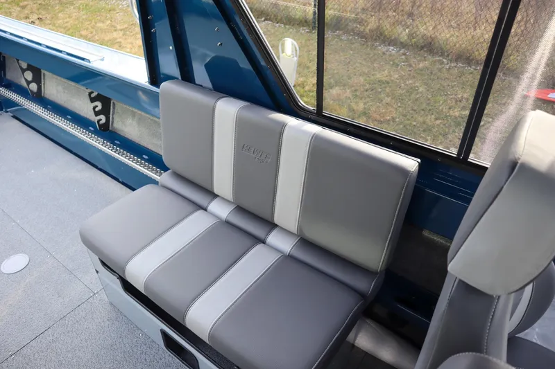 Slide: The Image of 2026 Hewescraft 240 Ocean Pro ET HT interior with gray seating and blue accents. - 10
