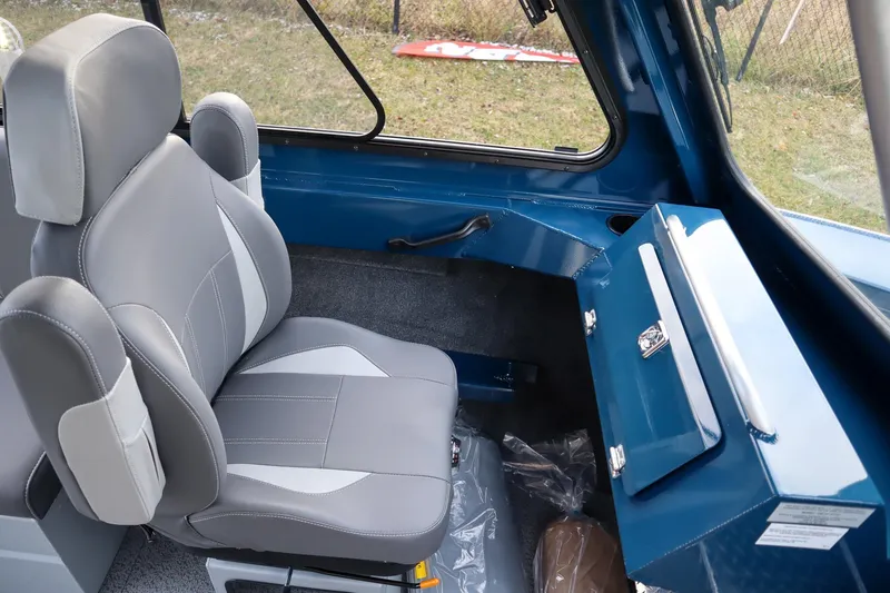 Slide: The Image of Interior of 2026 Hewescraft 240 Ocean Pro ET HT, featuring a gray seat and blue storage. - 11