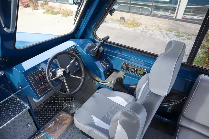 Slide: The Image of Interior of 2026 Hewescraft 240 Ocean Pro ET HT boat, featuring steering wheel and controls. - 12