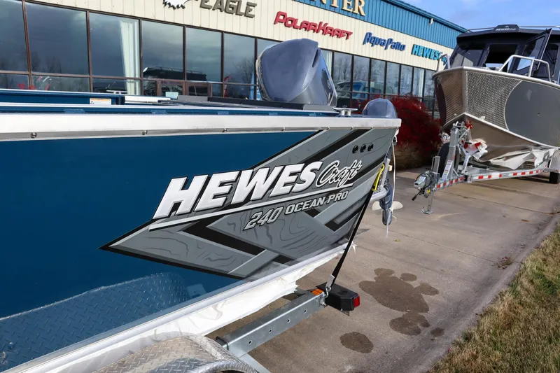 Slide: The Image of 2026 Hewescraft 240 Ocean Pro ET HT boat displayed outside dealership. - 15