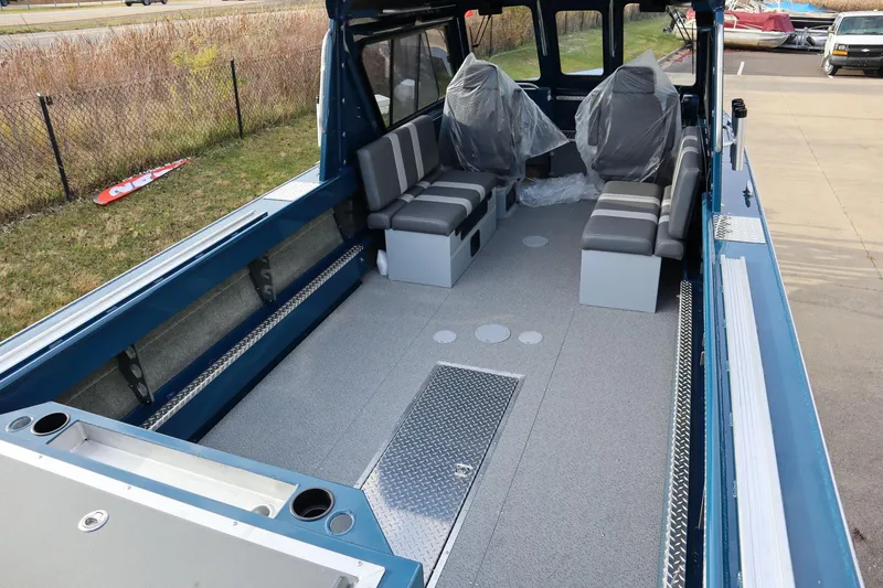 Slide: The Image of 2026 Hewescraft 240 Ocean Pro ET HT boat interior with seating and storage. - 4