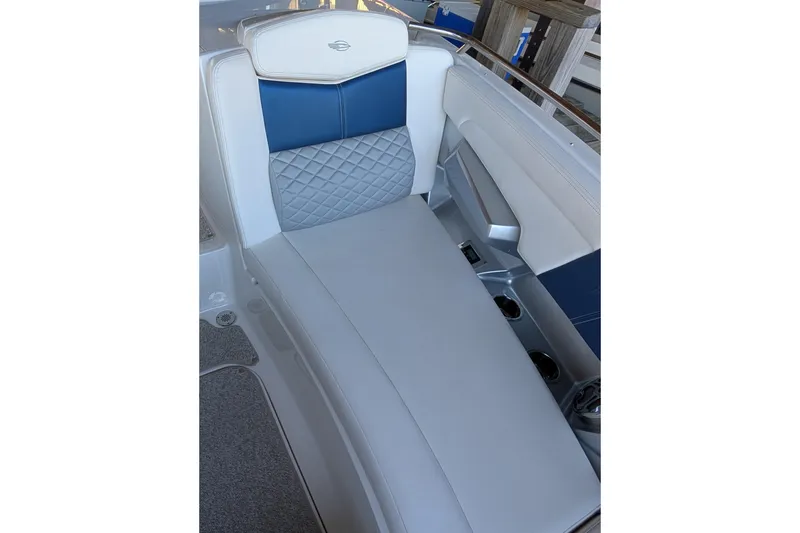 Slide: The Image of 2012 Chaparral 327 SSX boat interior with blue and gray cushioned seating. - 10