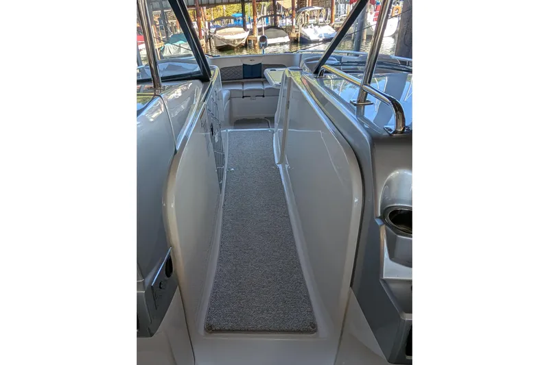 Slide: The Image of Interior view of 2012 Chaparral 327 SSX boat with carpeted walkway and seating area. - 11