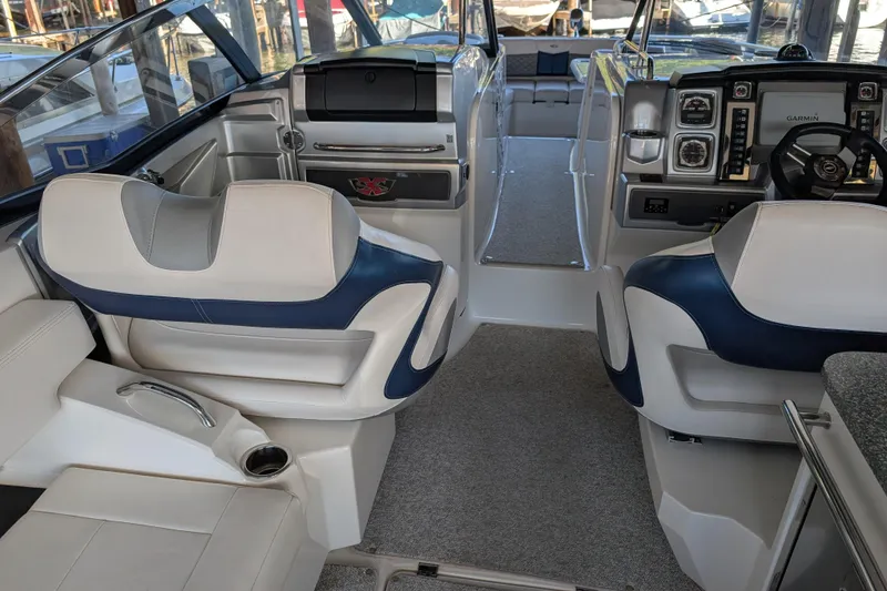 Slide: The Image of Interior of a 2012 Chaparral 327 SSX boat with modern seating and navigation controls. - 12