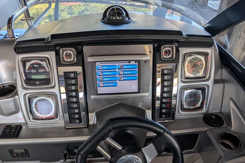 Slide: The Image of 2012 Chaparral 327 SSX dashboard with gauges, steering wheel, and Garmin GPS display. - 13