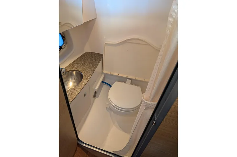 Slide: The Image of Compact bathroom in 2012 Chaparral 327 SSX boat with sink and toilet. - 17