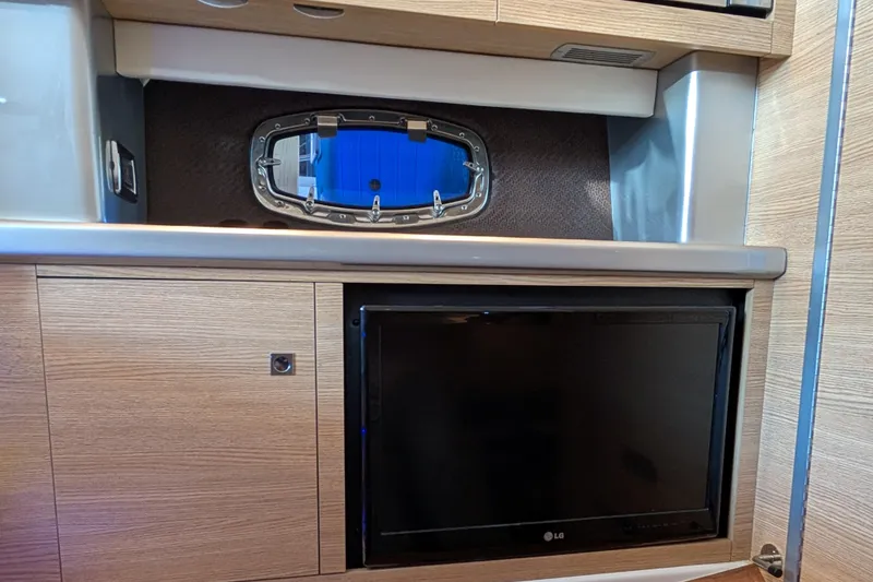 Slide: The Image of Interior of 2012 Chaparral 327 SSX boat with TV and porthole window. - 19