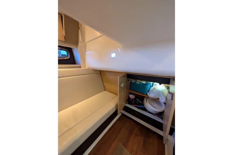 Slide: The Image of Interior of 2012 Chaparral 327 SSX boat with seating and storage cabinet. - 23