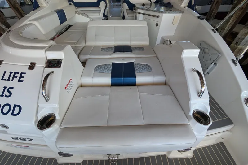 Slide: The Image of 2012 Chaparral 327 SSX boat interior with white and blue seating, cup holders, and "Life is Good" text. - 31