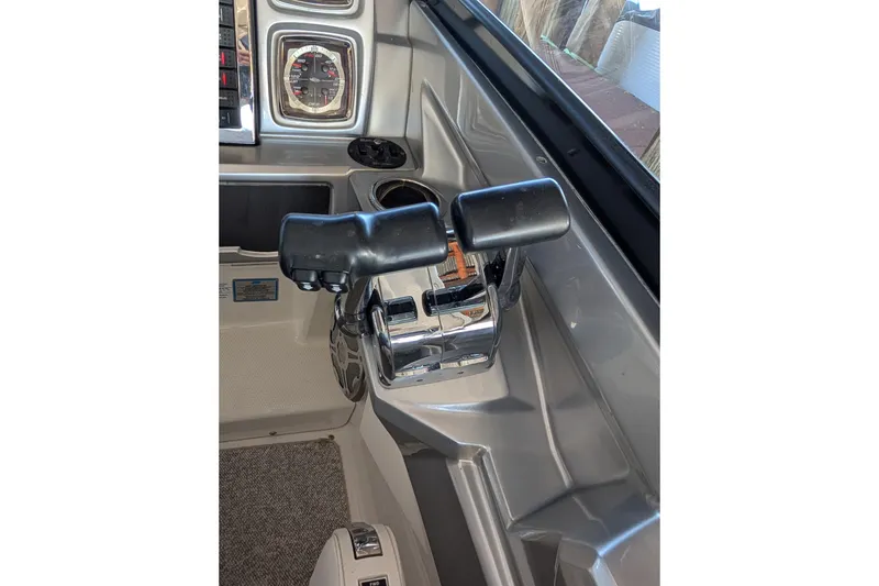 Slide: The Image of Control panel of a 2012 Chaparral 327 SSX boat, featuring throttle and gauges. - 32