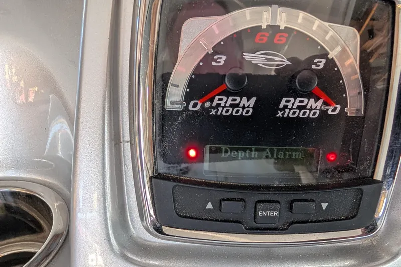 Slide: The Image of Dashboard of a 2012 Chaparral 327 SSX showing RPM gauges and depth alarm indicator. - 34