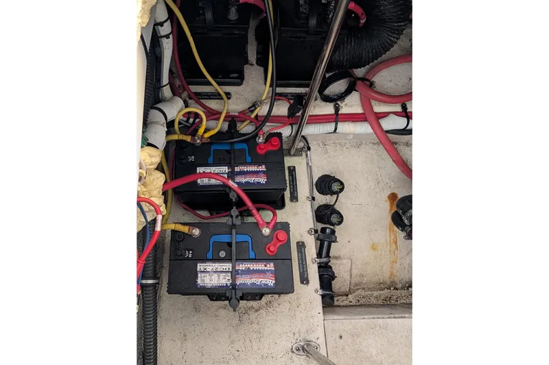 Slide: The Image of 2012 Chaparral 327 SSX boat battery compartment with wiring and connections. - 36