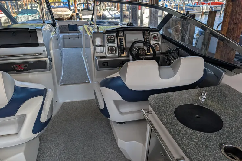 Slide: The Image of Interior of 2012 Chaparral 327 SSX boat with helm, seating, and kitchenette. - 5
