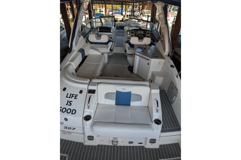 Slide: The Image of 2012 Chaparral 327 SSX boat interior with seating, helm, and "Life is Good" text. - 6