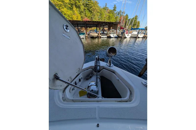 Slide: The Image of 2012 Chaparral 327 SSX boat anchor compartment with marina view in background. - 7