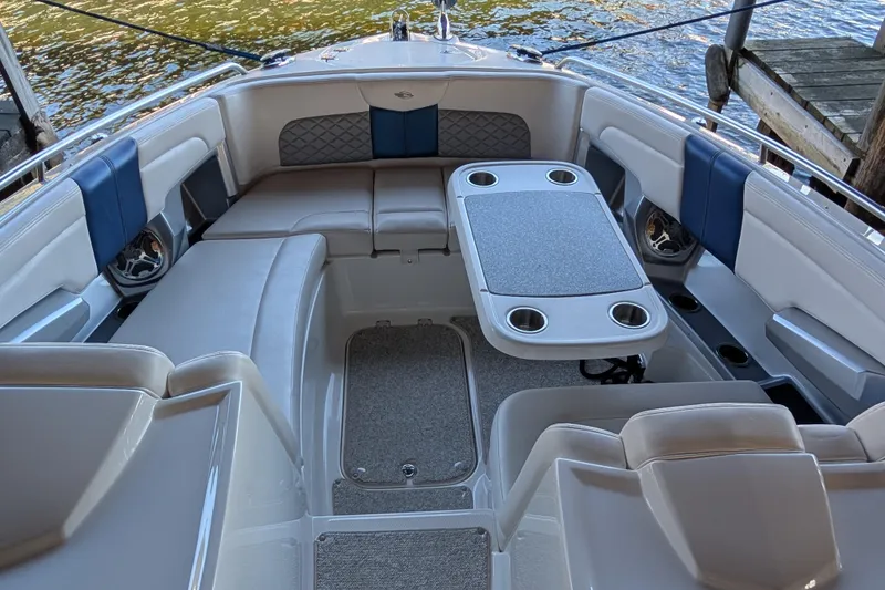 Slide: The Image of Luxurious seating area on a 2012 Chaparral 327 SSX boat with table and cup holders. - 8