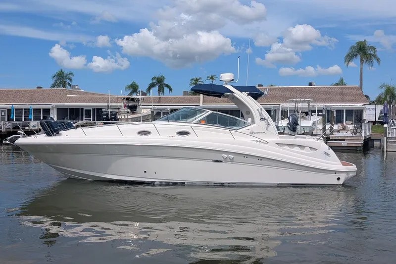 Slide: The Image of 2008 Sea Ray 340 Sundancer yacht docked at marina under blue sky. - 0