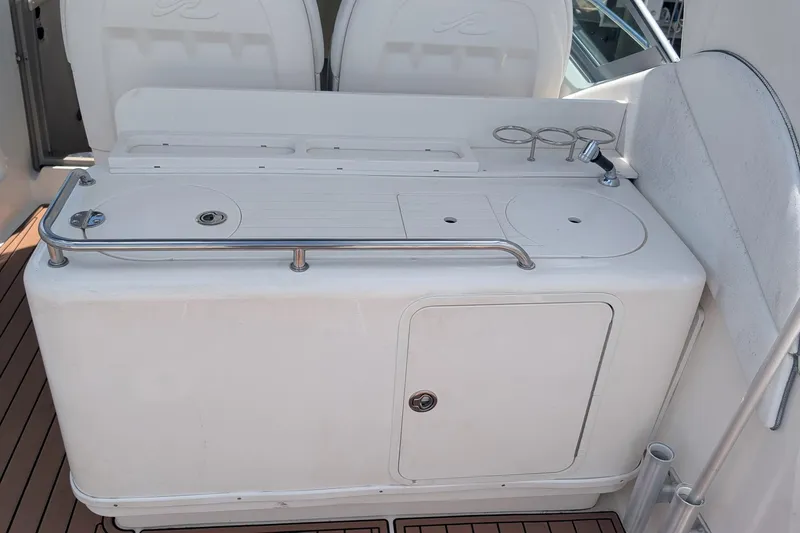 Slide: The Image of 2008 Sea Ray 340 Sundancer boat interior with a white kitchenette and cup holders. - 6