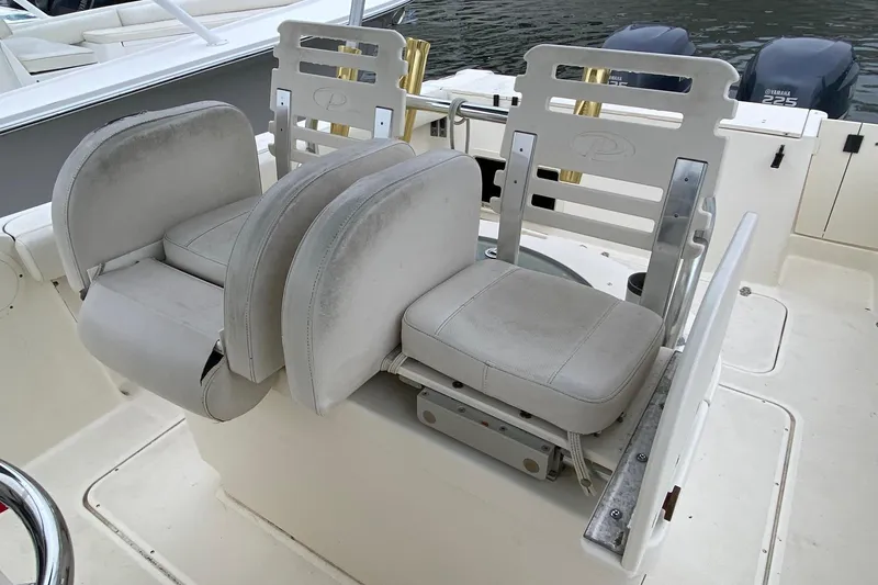 Slide: The Image of 2005 Pursuit 2870 Center Console boat seats with dual Yamaha 225 engines in background. - 4