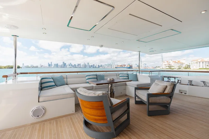 Slide: The Image of Luxurious 2018 Benetti Fast 125 yacht deck with elegant seating and stunning waterfront view. - 10