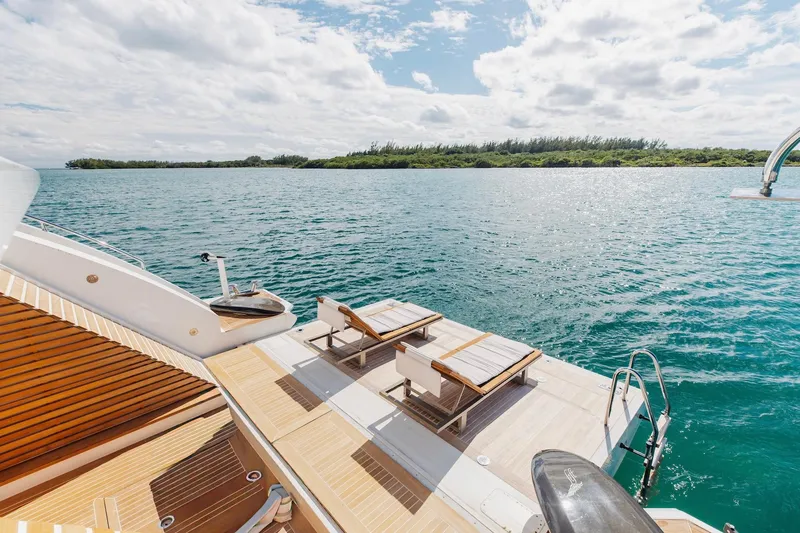 Slide: The Image of Luxurious 2018 Benetti Fast 125 yacht deck with sun loungers overlooking serene ocean waters. - 27