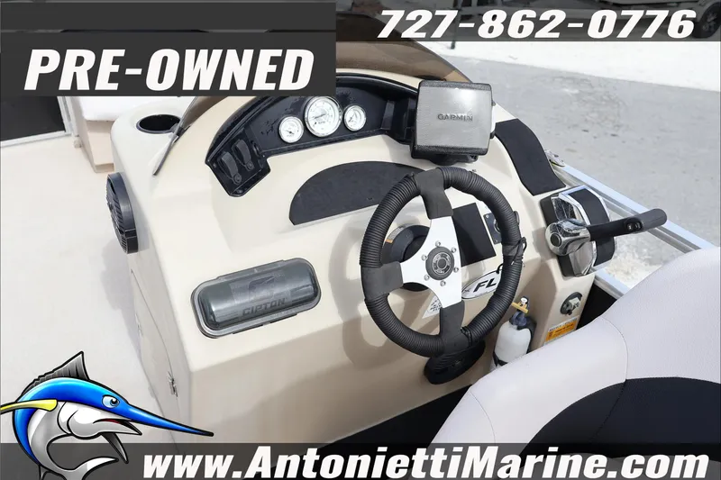 Slide: The Image of Pre-owned 2012 Harris FloteBote Cruiser CX 200 boat dashboard with steering wheel and controls. - 9