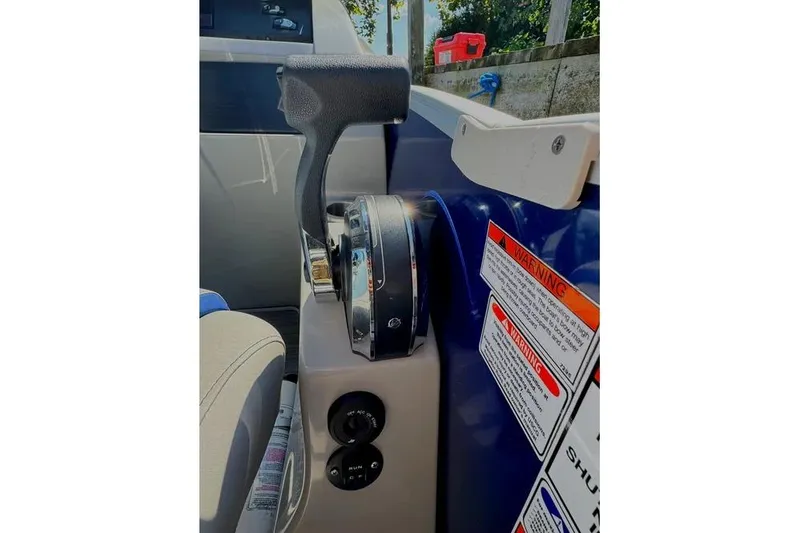 Slide: The Image of Throttle control panel of a 2022 Bennington 23 LTFB boat with warning labels. - 15
