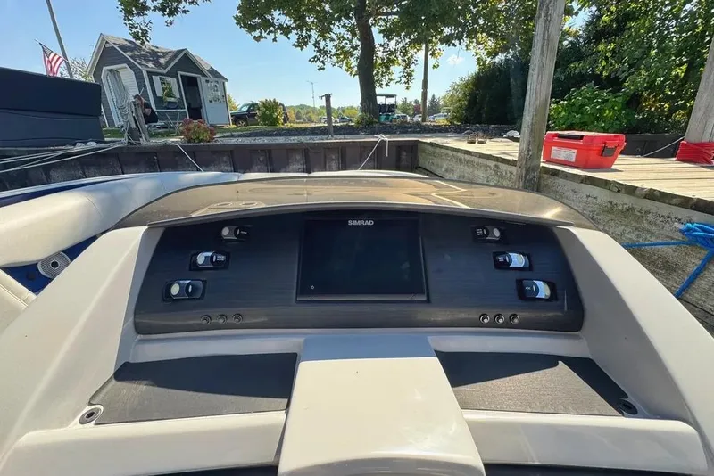 Slide: The Image of 2022 Bennington 23 LTFB boat dashboard with Simrad display and control panel. - 18