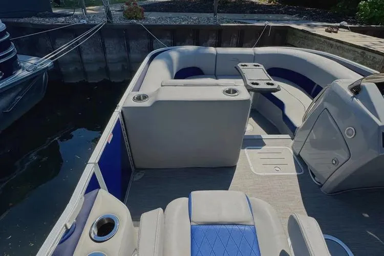 Slide: The Image of 2022 Bennington 23 LTFB pontoon boat interior with seating and cup holders. - 20