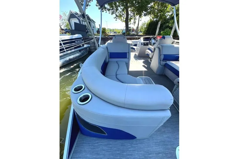 Slide: The Image of 2022 Bennington 23 LTFB pontoon boat interior with plush seating and cup holders. - 21