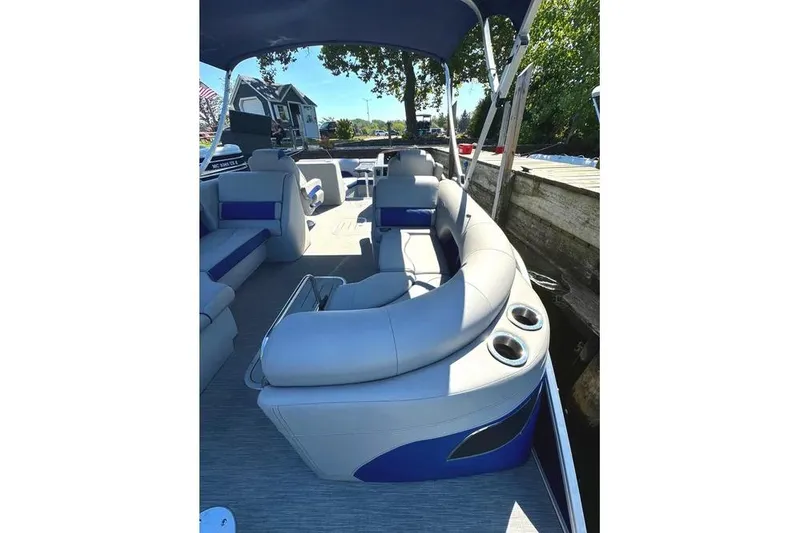 Slide: The Image of 2022 Bennington 23 LTFB pontoon boat interior with plush seating and cup holders. - 24