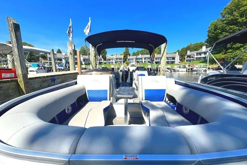 Slide: The Image of 2022 Bennington 23 LTFB pontoon boat docked, featuring spacious seating and canopy. - 3