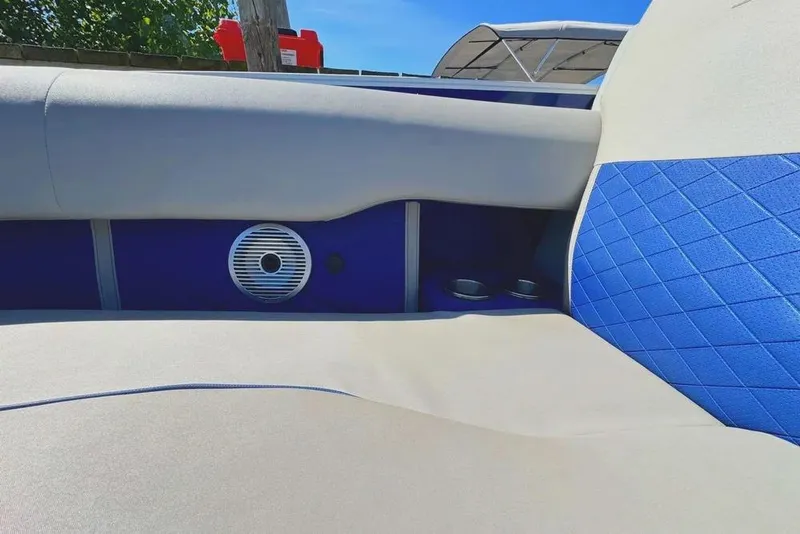 Slide: The Image of 2022 Bennington 23 LTFB boat interior with blue and white seating and speaker. - 7
