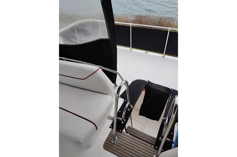 Slide: The Image of 1990 Bayliner 3888 Motoryacht interior with seating and water view. - 13
