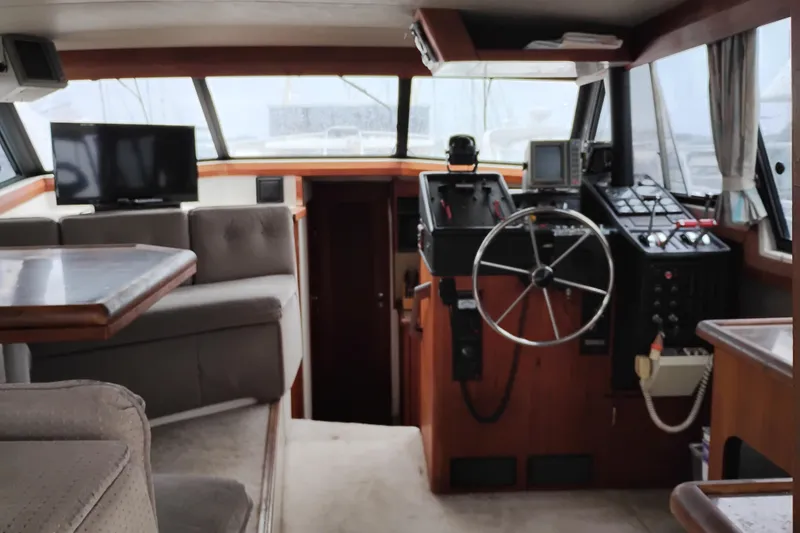 Slide: The Image of Interior of 1990 Bayliner 3888 Motoryacht with helm, seating, and navigation equipment. - 16