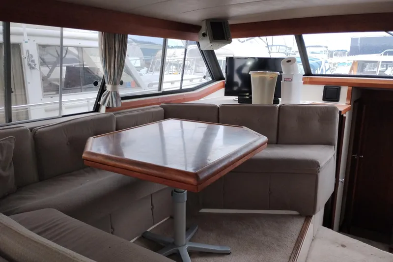 Slide: The Image of Interior of 1990 Bayliner 3888 Motoryacht with seating area and table. - 18