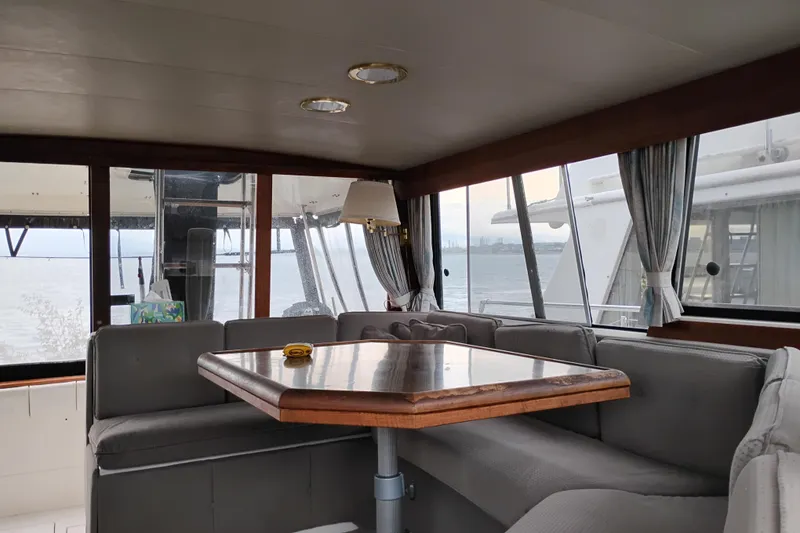 Slide: The Image of Interior of 1990 Bayliner 3888 Motoryacht with dining area and panoramic windows. - 19