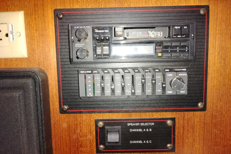 Slide: The Image of 1990 Bayliner 3888 Motoryacht audio control panel with cassette player and speaker selector. - 23