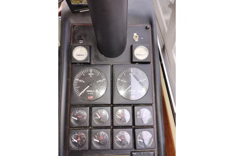 Slide: The Image of Dashboard of a 1990 Bayliner 3888 Motoryacht with various gauges and controls. - 26