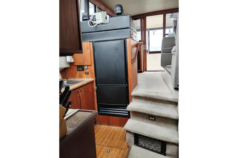 Slide: The Image of Interior of 1990 Bayliner 3888 Motoryacht with kitchen and carpeted stairs. - 32