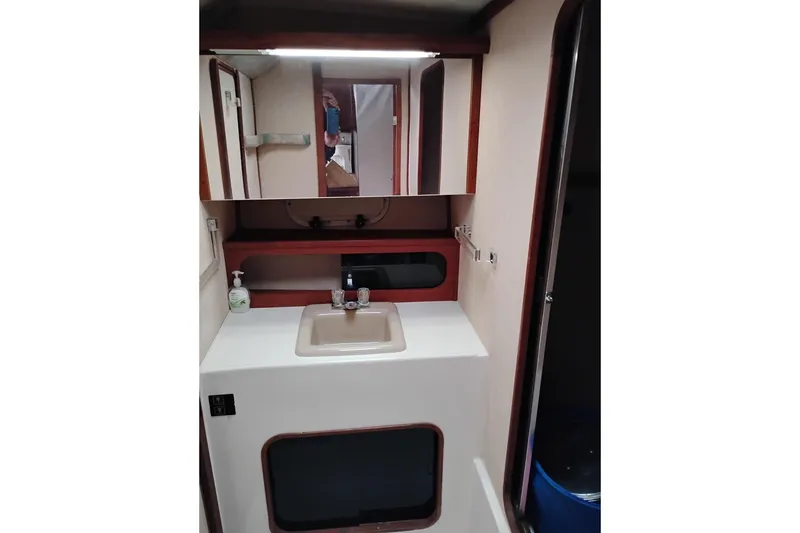 Slide: The Image of 1990 Bayliner 3888 Motoryacht bathroom with sink, mirror, and storage. - 36
