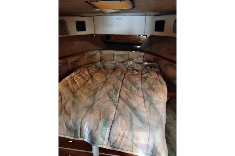 Slide: The Image of 1990 Bayliner 3888 Motoryacht cabin interior with cozy bed and storage. - 39