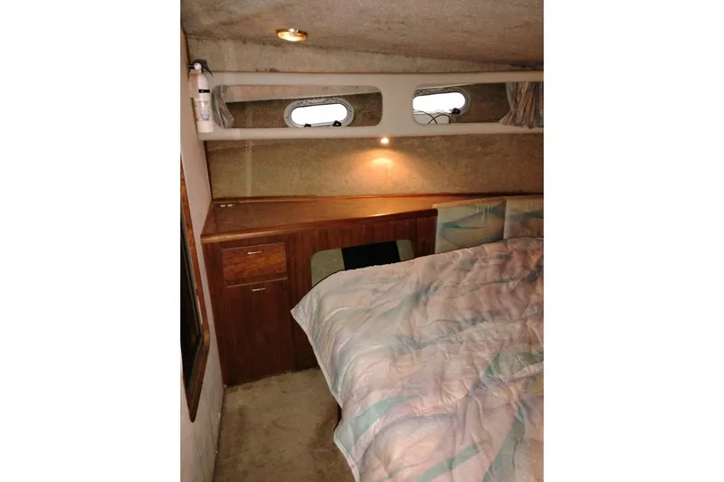 Slide: The Image of Cozy cabin interior of 1990 Bayliner 3888 Motoryacht with bed and wooden cabinetry. - 40