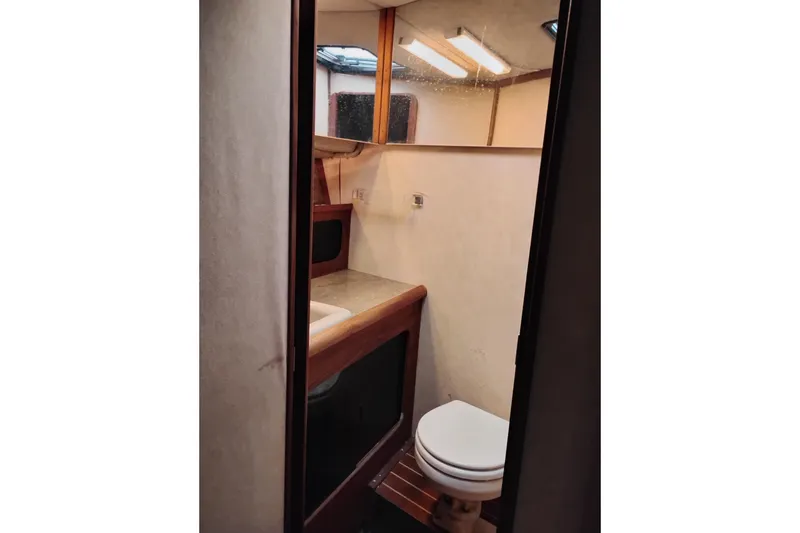 Slide: The Image of 1990 Bayliner 3888 Motoryacht bathroom with sink, mirror, and toilet. - 42