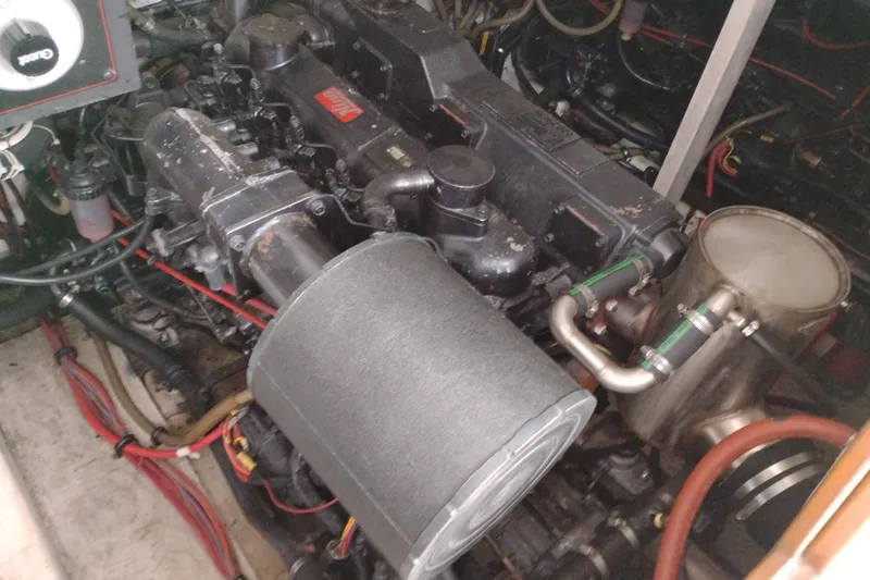 Slide: The Image of Engine compartment of a 1990 Bayliner 3888 Motoryacht, showcasing mechanical components and wiring. - 45