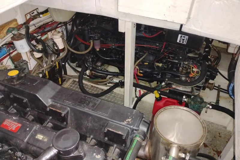 Slide: The Image of Engine room of a 1990 Bayliner 3888 Motoryacht with visible machinery and wiring. - 46